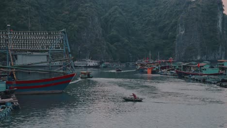Local-boats-sailing-and-few-boats-parked-at-Lan-ha-bay-in-Vietnam