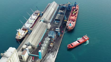 Aerial-drone-view-of-tankers-docked-at-the-marina,-in-cloudy-Savona-city,-Italy