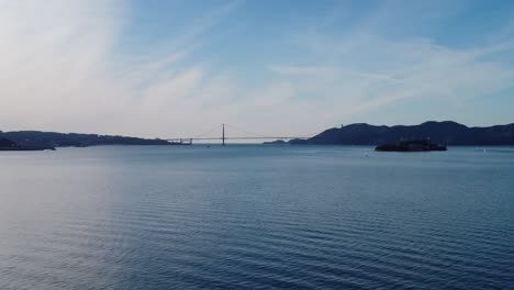 Aerial-Shot-Slowly-Zooming-in-the-waters-around-Treasure-Island-with-the-Golden-Gate-in-the-distance