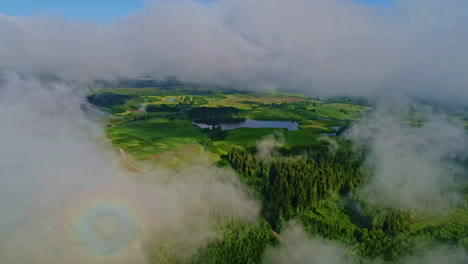 Wonderful-landscape-view-of-Latvia-countryside-through-opened-misty-clouds---aerial-dolly-forward-shot