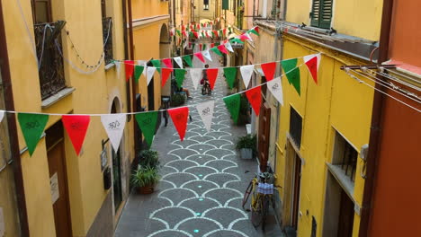 Aerial-view-flying-through,-quiet,-narrow-streets-of-Pietra-Ligure,-Italy