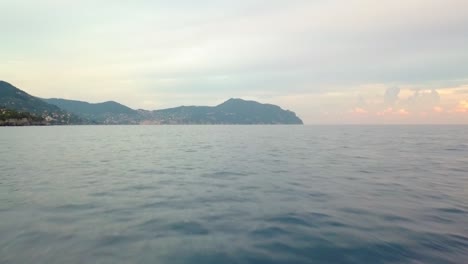 Aerial-drone-view-over-sup-boarders,-floating-in-calm-waters-of-north-Italy