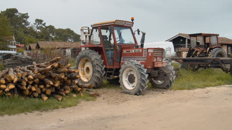 Classic-old-farming-tractor-in-farmstead-location,-handheld-view