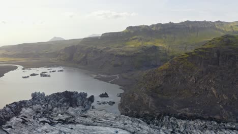 Aerial-view-of-Sólheimajökull-Glacier-valley-in-Iceland,-showcasing-pristine-wilderness---panning-back