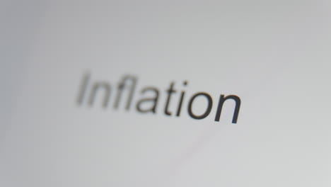 A-close-up-of-a-digital-screen-showing-the-word-"inflation"-while-the-focus-racks-back-and-forth-across-it