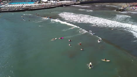 Aerial-view-around-surfers-on-the-coast-of-Recco,-sunny-day-in-Liguria,-Italy
