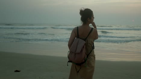 Woman-with-a-backpack-looking-at-the-sea