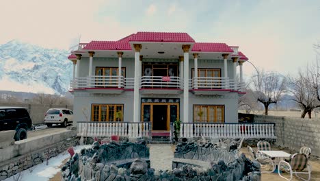 Aerial-tilt-up-shot-of-Signature-hotel-in-Skardu-city,-Pakistan