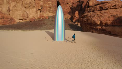 Man-walking-around-the-Gisela-Colon-parabolic-monolith,-at-the-Desert-x,-in-sunny-Al-ula,-Saudi-Arabia---Aerial-view