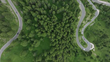 A-bird's-eye-view-captures-cars-traversing-the-serpentine-roads-near-Selva-Pass-in-the-Dolomites,-Trentino,-South-Tyrol,-Italy