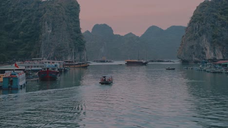 Local-boats-sailing-on-Lan-Ha-Bay-during-sunset-in-Vietnam