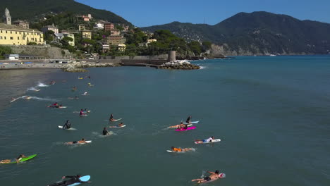 Aerial-view-of-surfers-waiting-for-waves-on-the-coast-of-Recco,-Liguria,-Italy