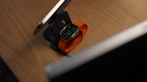 Placing-Apple-Watch-Ultra-2-On-Magnetic-Charging-Base-Stand-On-Table