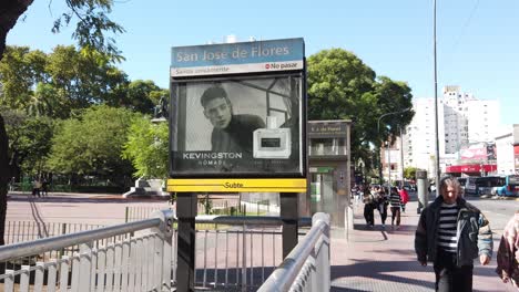 Underground-subway-station-entrance,-Buenos-Aires-people-walk-green-park-traffic-in-Rivadavia-Avenue,-Argentina,-public-Pueyrredon-plaza,-San-Jose-de-Flores-neighborhood