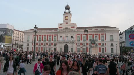 View-of-large-crowds-of-people-gathering-and-spending-their-evening-at-the-Puerta-del-Sol,-an-iconic-landmark-of-Madrid