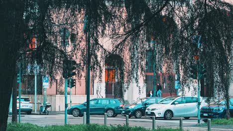 Vehicles-of-Milan-city-wait-to-move-off,-residents-stand-together-chatting