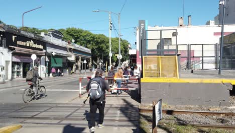 Local-people-walk-at-train-city-railway-sarmiento-station-of-buenos-aires-city-argentina,-public-transport-landmark-in-Flores-neighborhood