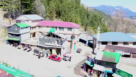 Aerial-view-of-a-small-town-in-Nathya-Gali,-at-Ayubia-National-Park-with-a-curvy-road,-Pakistan