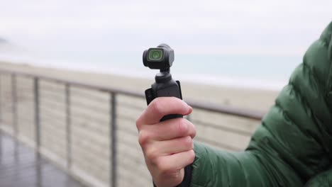 Man-Holding-A-Pocket-Camera,-Shooting-A-Video-Concept