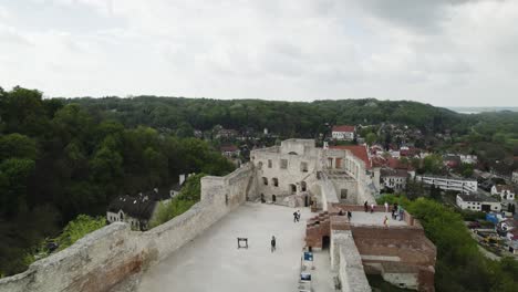 Tourists-At-Kazimierz-Dolny-Castle-With-A-View-Of-Town-And-Catholic-Church