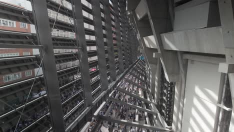 aerial-tilt-up-shot-inside-new-Santiago-Berbabeu-courtain-wall-facade-with-fan-supporters-bellow-on-a-sunny-spring-day