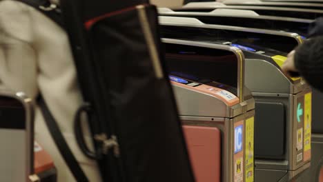 Shibuya-Train-Station,-Commuters-walking-through-ticket-gates,-Tokyo,-Japan