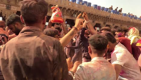 pov-shot-Many-people-are-enjoying-Dhuleti-excitedly-and-joyfully-at-the-entrance-of-the-temple-and-different-groups-are-enjoying-Dhuleti-very-nicely-in-different-dresses