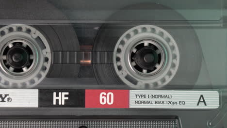 Spinning-Reels-of-Audio-Cassette-Tape,-Playback-or-Recording-Sound,-Macro-Close-Up