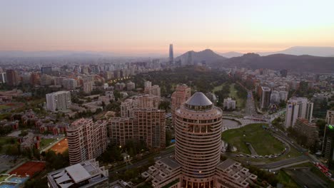 Santiago-de-Chile-Aerial-Las-Condes-Neighborhood-Cityscape-Town-buildings-Andean-mountain-range-background,-Golf-Club,-Mandarin-hotel-and-Costanera-Tower