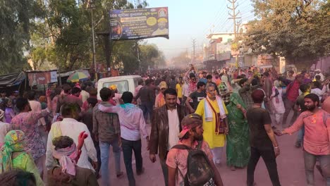 pov-shot-by-people-going-towards-the-temple-on-the-road-making-the-surrounding-area-colorful-with-different-dances-and-colors