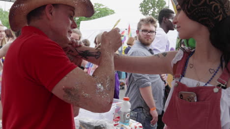 A-festival-goer-gets-some-glitter-at-the-MidMo-PrideFest
