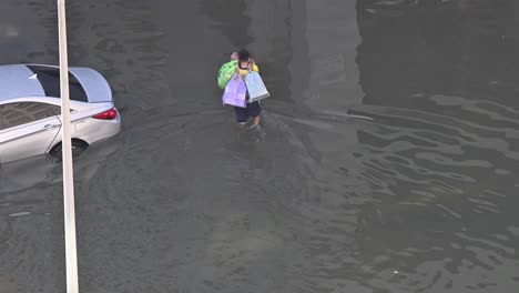 Record-breaking-rains-on-April-19,-2024,-leave-residents-to-navigate-a-flooded-road-in-the-northern-Emirates-of-the-UAE