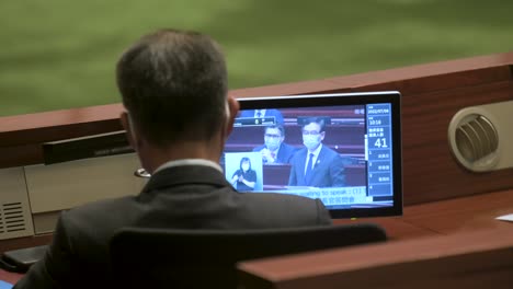 A-lawmaker-listens-to-other-colleagues-during-Hong-Kong's-annual-policy-address-at-the-Legislative-Council-main-chamber-in-Hong-Kong