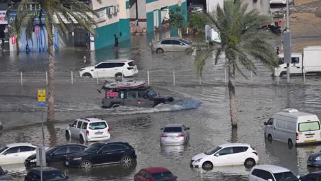 On-April-19,-2024,-traffic-navigated-through-a-flooded-road-in-the-northern-Emirates-of-the-UAE-after-record-breaking-rains-hit-the-country