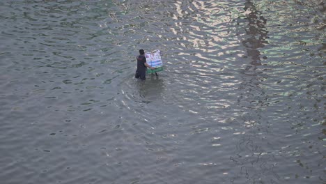 Record-breaking-rains-on-April-19,-2024,-leave-residents-to-navigate-a-flooded-road-in-the-northern-Emirates-of-the-UAE