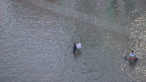 On-April-19,-2024,-Residents-navigated-through-a-flooded-road-in-the-northern-Emirates-of-the-UAE-after-record-breaking-rains-hit-the-country