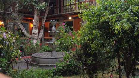 Static-shot-of-central-courtyard-with-flower-plants-in-old-hotel