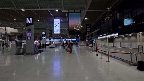 People-walking-inside-the-entrance-hall-at-the-Narita-airport-in-Tokyo,-Japan