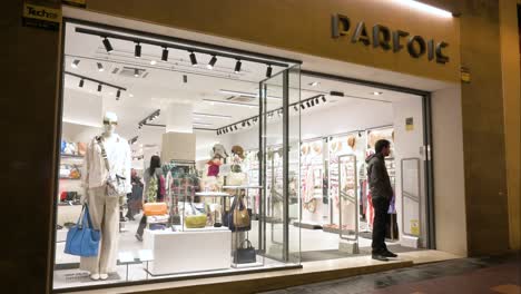 A-shopper-stands-at-the-entrance-of-the-Portuguese-women's-accessories-brand-Parfois-store-in-Spain