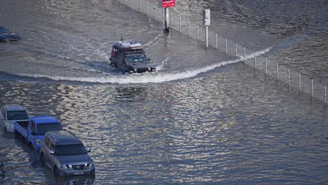 On-April-19,-2024,-traffic-navigated-through-a-flooded-road-in-the-northern-Emirates-of-the-UAE-after-record-breaking-rains-hit-the-country