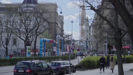 Slow-Motion-Shot-Of-Tourists-Walking-By-The-Street-Near-Old-Buildings-In-Vienna,-Austria