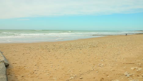 White-foaming-waves-rolling-on-the-sandy-beach-at-Ile-De-Re-in-France