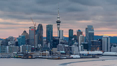 Auckland,-New-Zealand-skyline-and-port---vibrant-colorful-sunset-to-nighttime-time-lapse