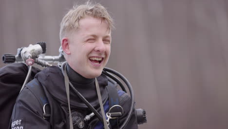 Swedish-man-in-ice-diving-gear-laughs-and-chats-after-dive,-close-up