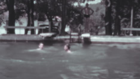 Man-and-Woman-Jump-into-the-Lake-from-a-Trampoline-in-Summer-of-1930s