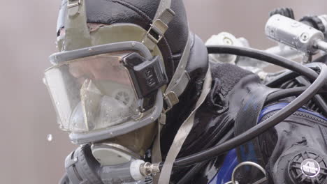 Dramatic-hero-shot-as-water-drips-off-diver-with-full-face-mask-and-drysuit