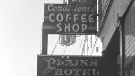 Two-Women-Standing-in-Front-of-Plains-Hotel-in-Wyoming-in-Sunny-Day-of-1930s