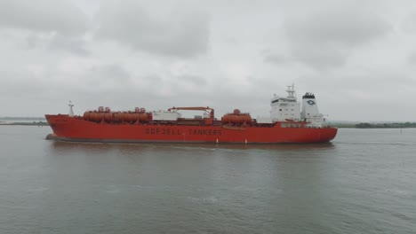 Eine-Von-Rechts-Nach-Links-Schwenkende-Luftaufnahme-Eines-Odfjell-Tankers,-Der-Unter-Düsterem-Himmel-Im-Houston-Ship-Channel-In-Houston,-Texas,-An-Morgan&#39;s-Point-Vorbeifährt