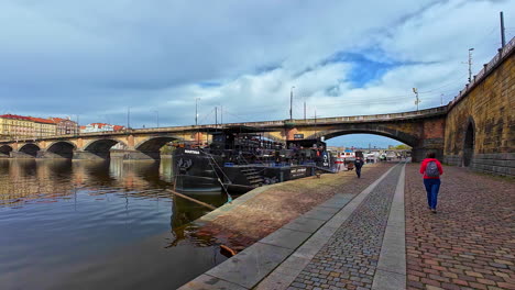 Low-angle-shot-of-tourists-looking-at-the-historic-Charles-Bridge-in-Prague,-Czech-Republic-on-a-cloudy-day