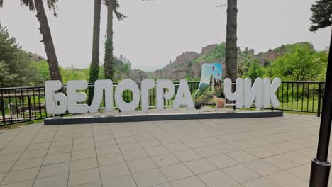 Town-sign-written-in-large-Cyrillic-typography-letters-at-viewpoint
